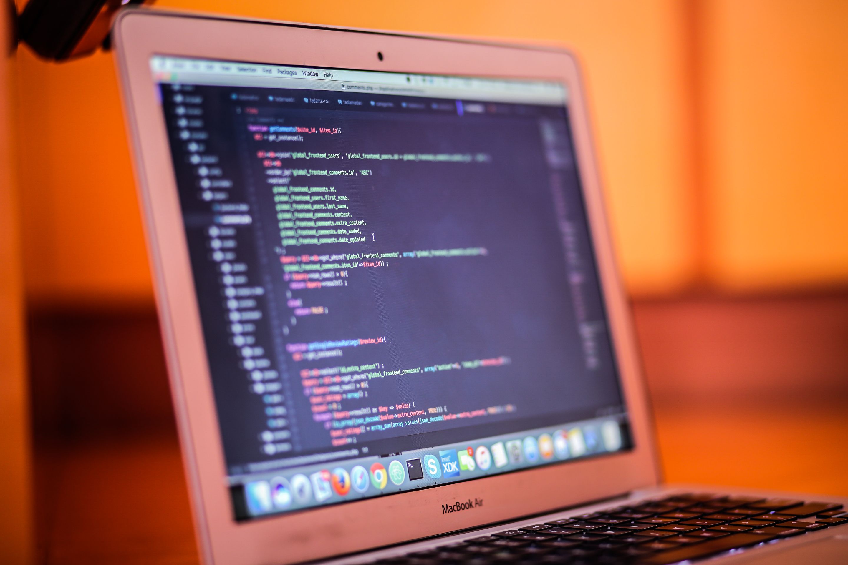 Low-light close-up of a laptop screen full of code